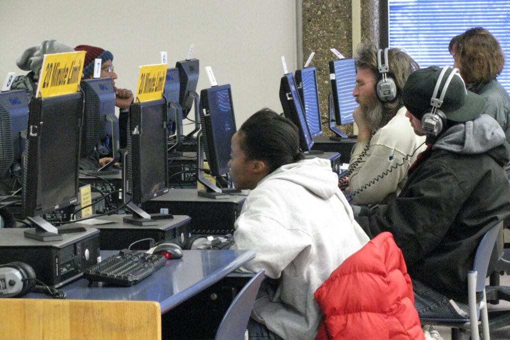 people using computers in a public library