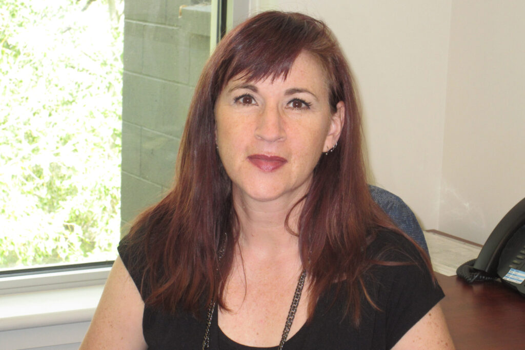 woman sitting down smiling for a photo