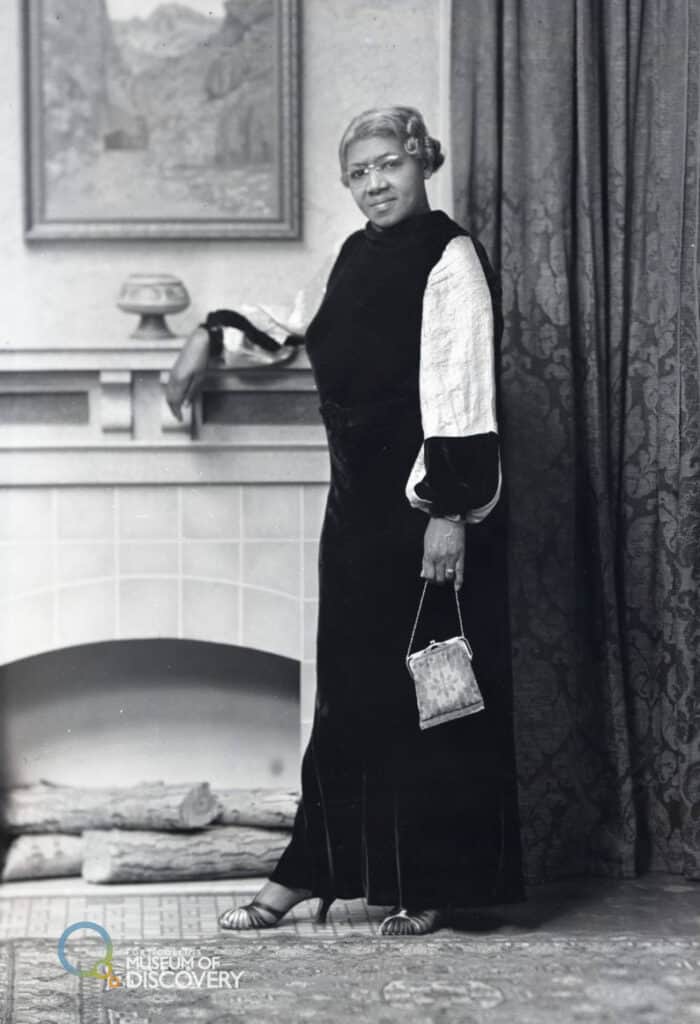 ella mae cook posing for a photo by a fireplace