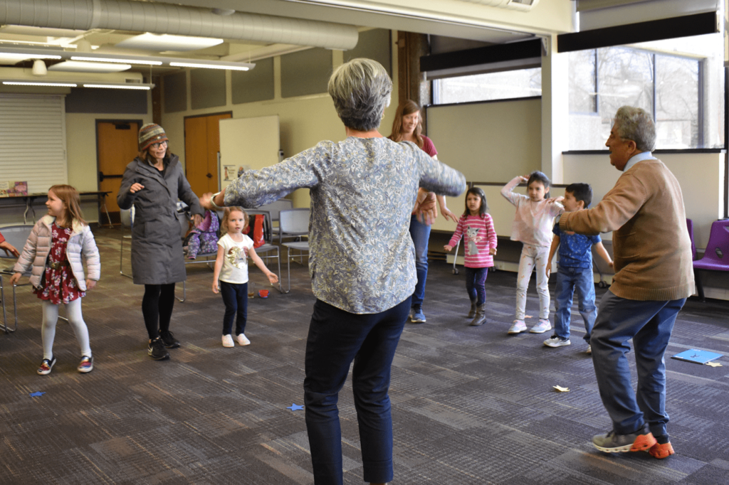 woman and man leading a children's storytime