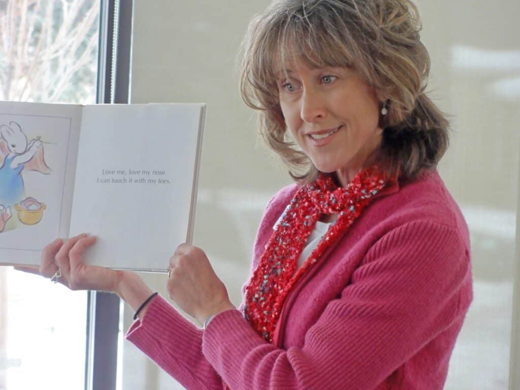 woman holding up a book