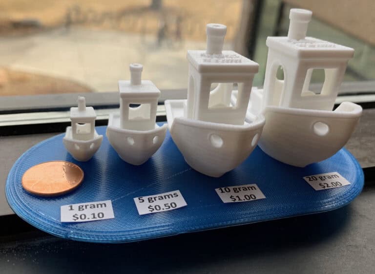 3D print of four boats to show size of grams and cost