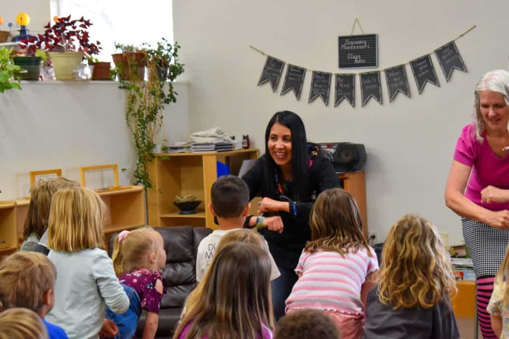 latina woman guiding a children's storytime