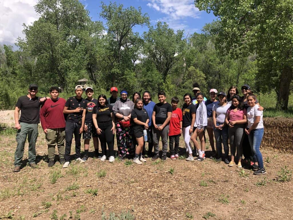 group of teens and adults smiling for a photo