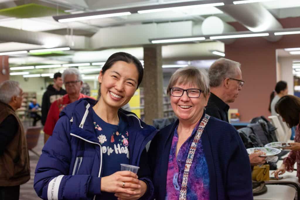 Pair of two women smiling for a photograph.