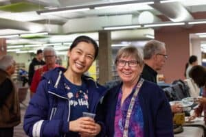 Pair of two women smiling for a photograph.