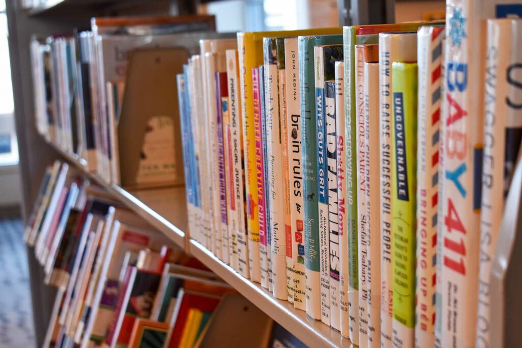 Colorful spines of books shelved at a library.