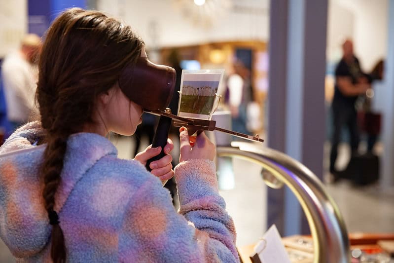 Young girl looking at an image through photo viewers