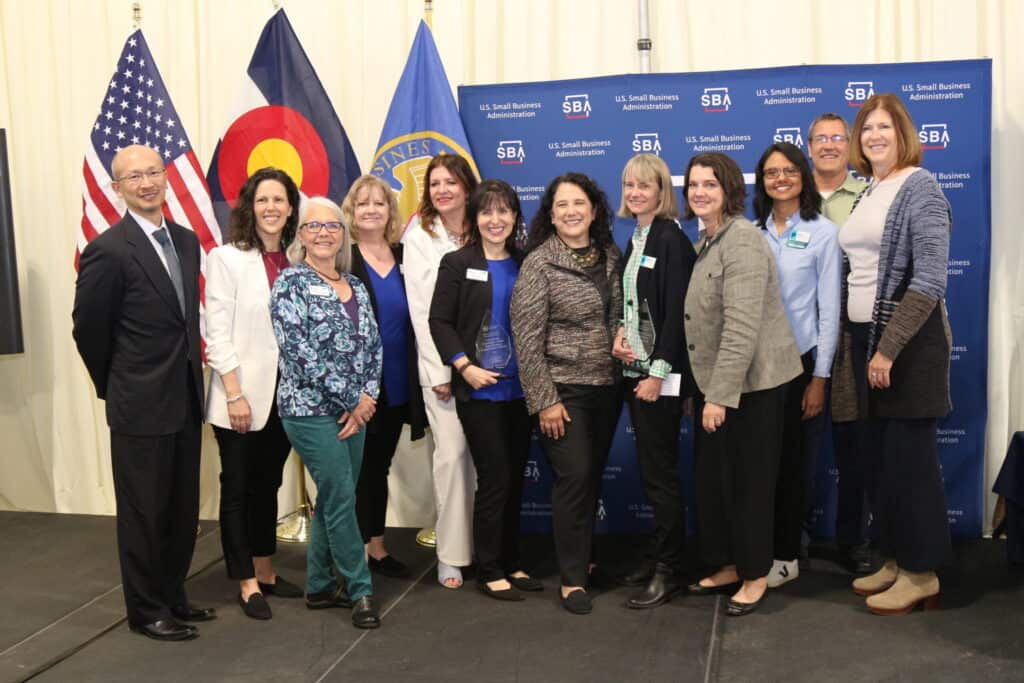 Grupo de personas sonrientes delante de banderas