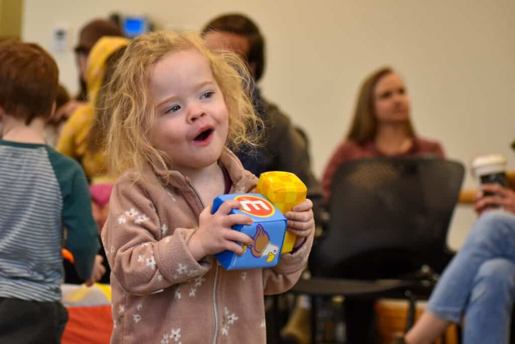 Young girl holding colorful blocks