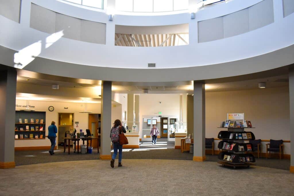 A spacious, white, circular room with a large circular ceiling