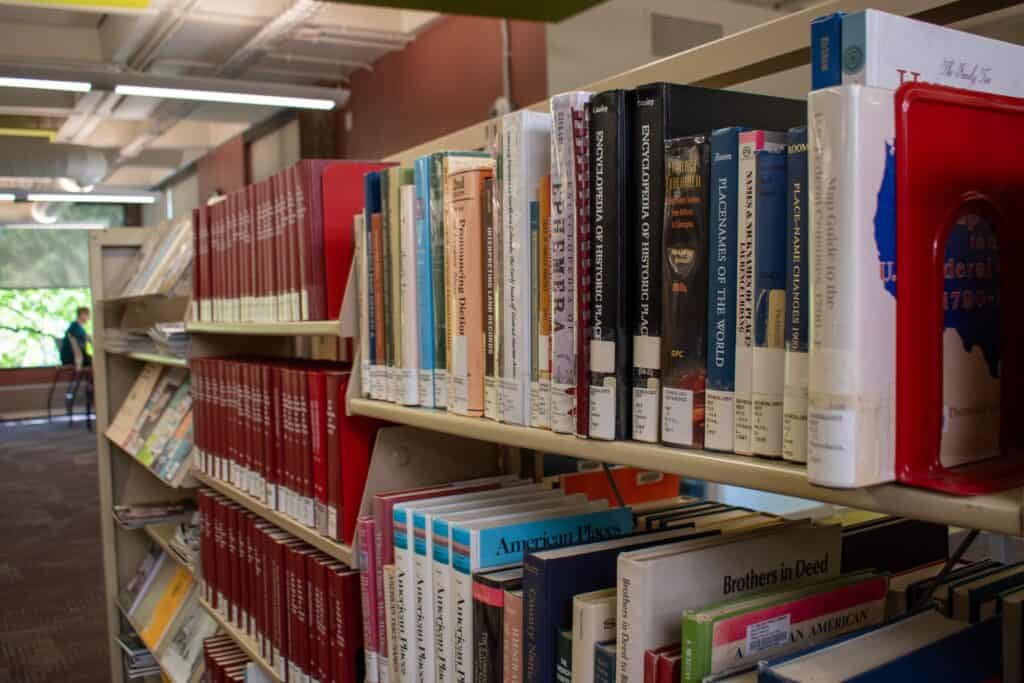 Shelves of colorful genealogy books used for research in a library