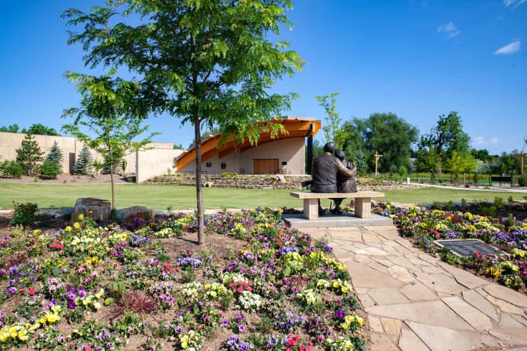 Grassy field in front of a wooden pavilion at the Gardens on Spring Creek