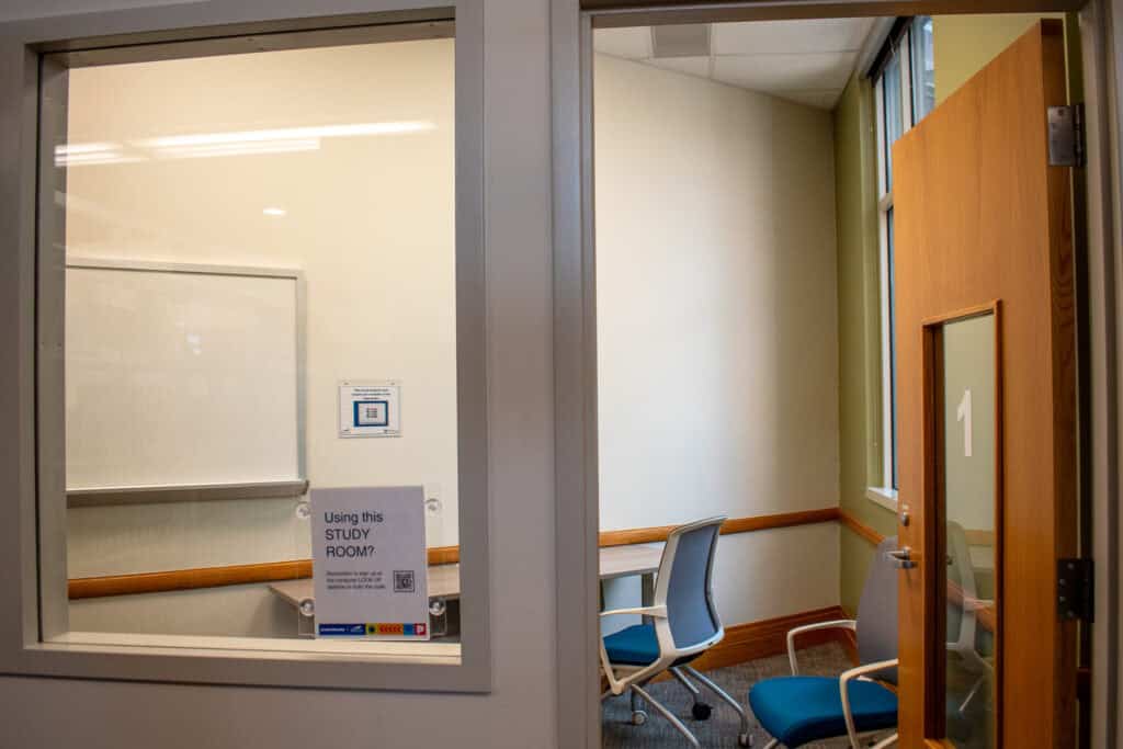 Small study room with the number 1 engraved on a glass and wooden door