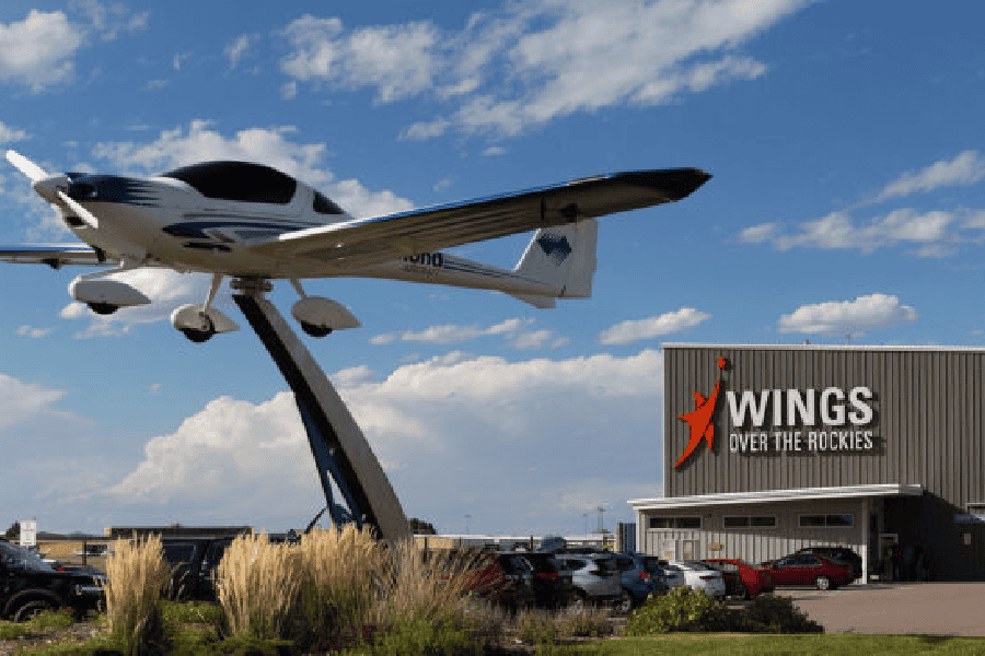 Plane suspended in the air in front of the Wings over the Rockies Museum