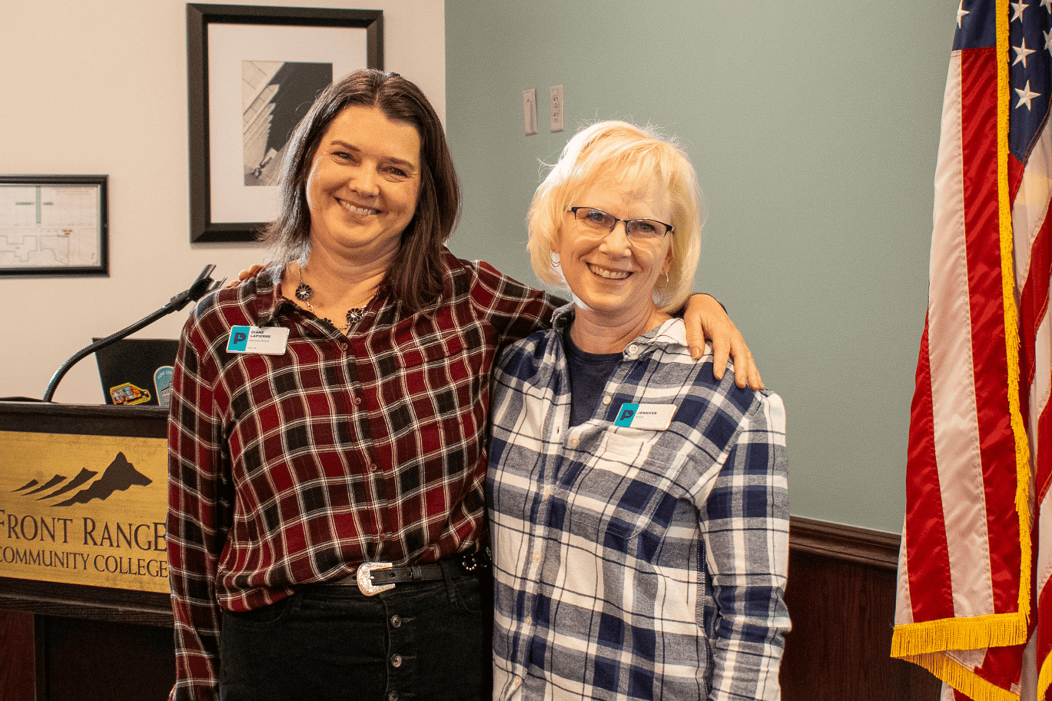 Two smiling women posing for photo