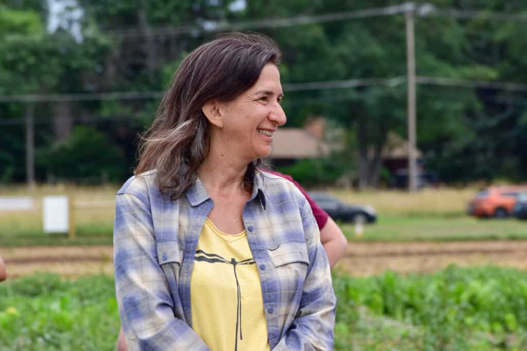 Mujer sonriente en un campo mirando a la derecha