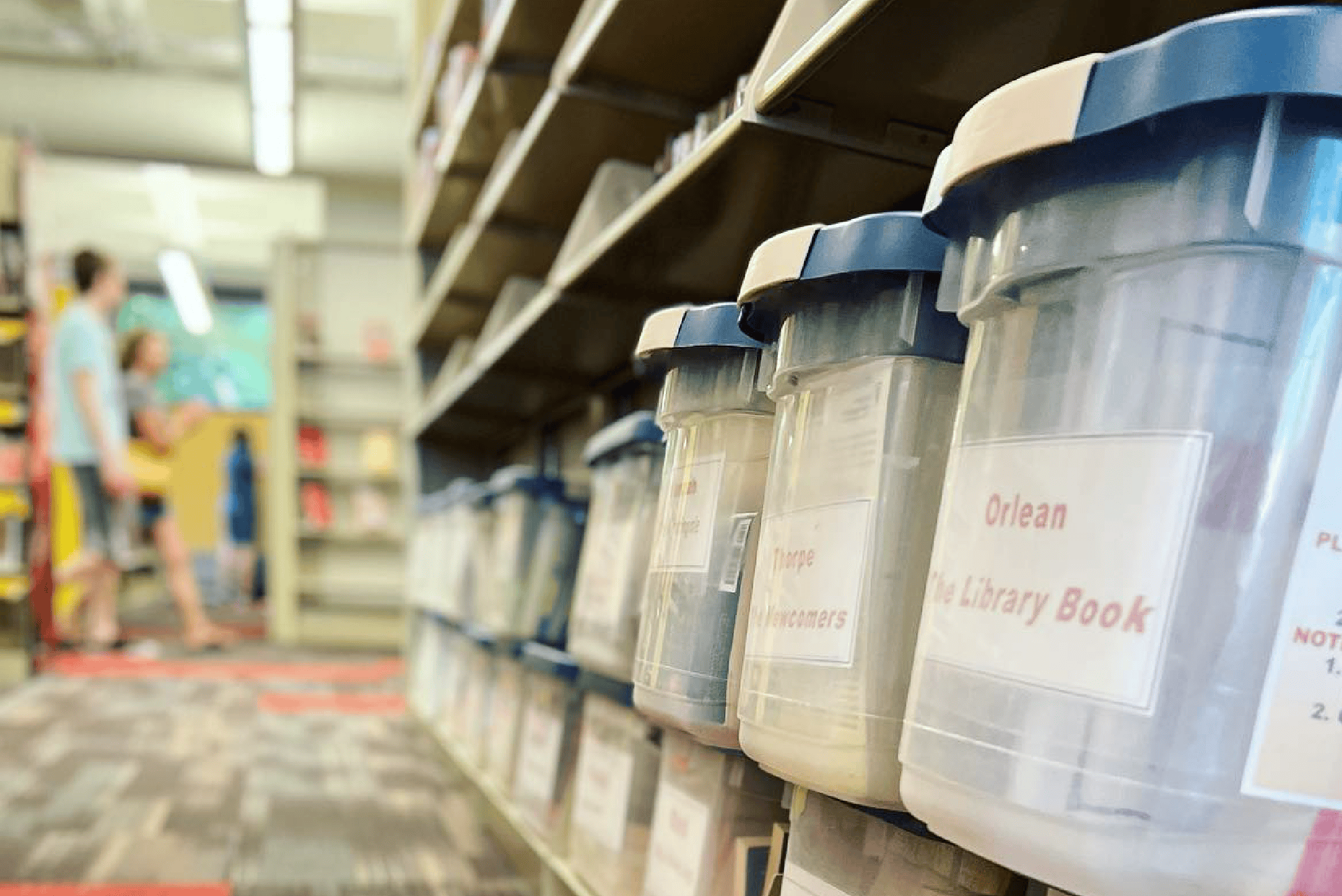 Plastic bins on a shelf in a library