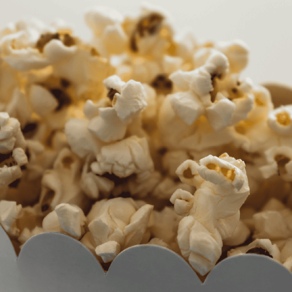 Close up of buttered popcorn in a scalloped edge white container