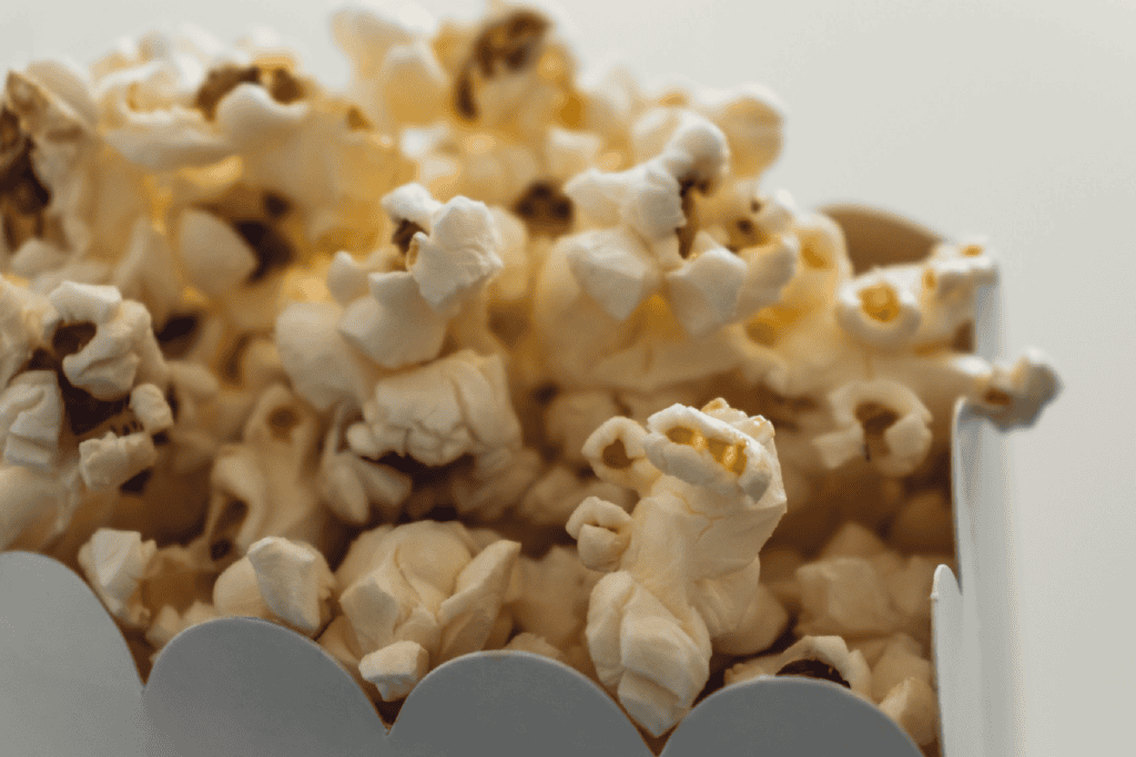 Close up of buttered popcorn in a scalloped edge white container