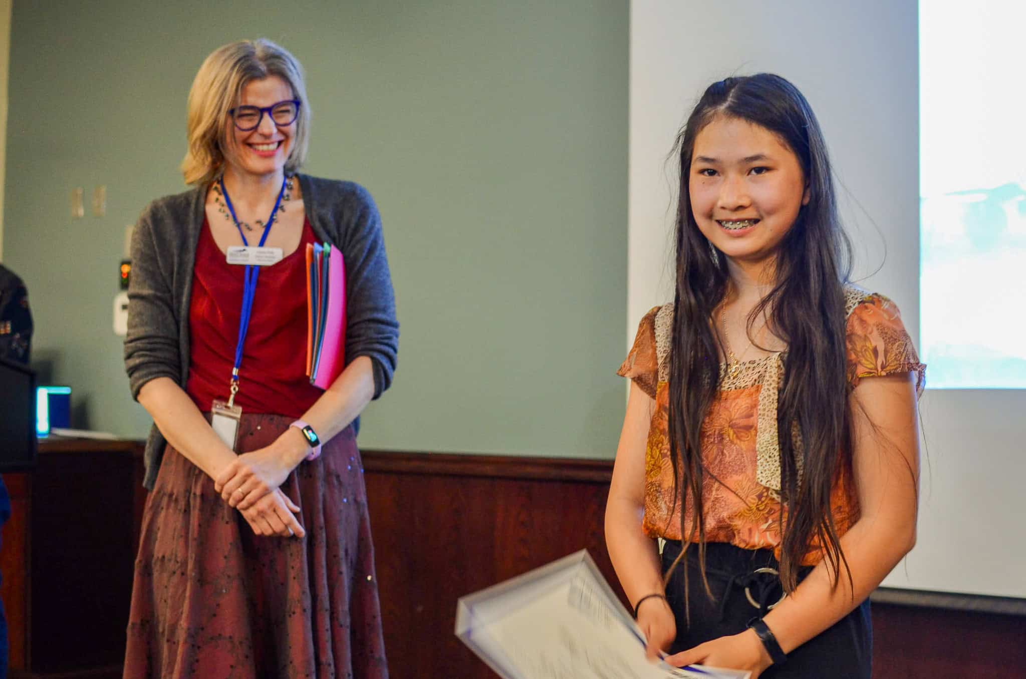 Young girl smiling for a photo after winning a poetry award