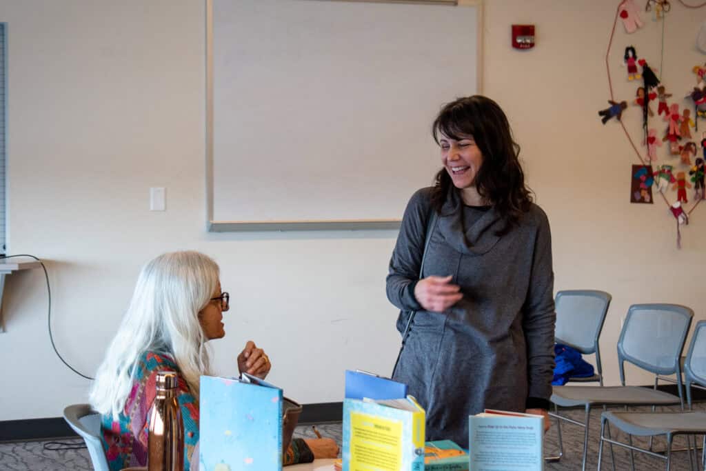 Two women laughing and talking