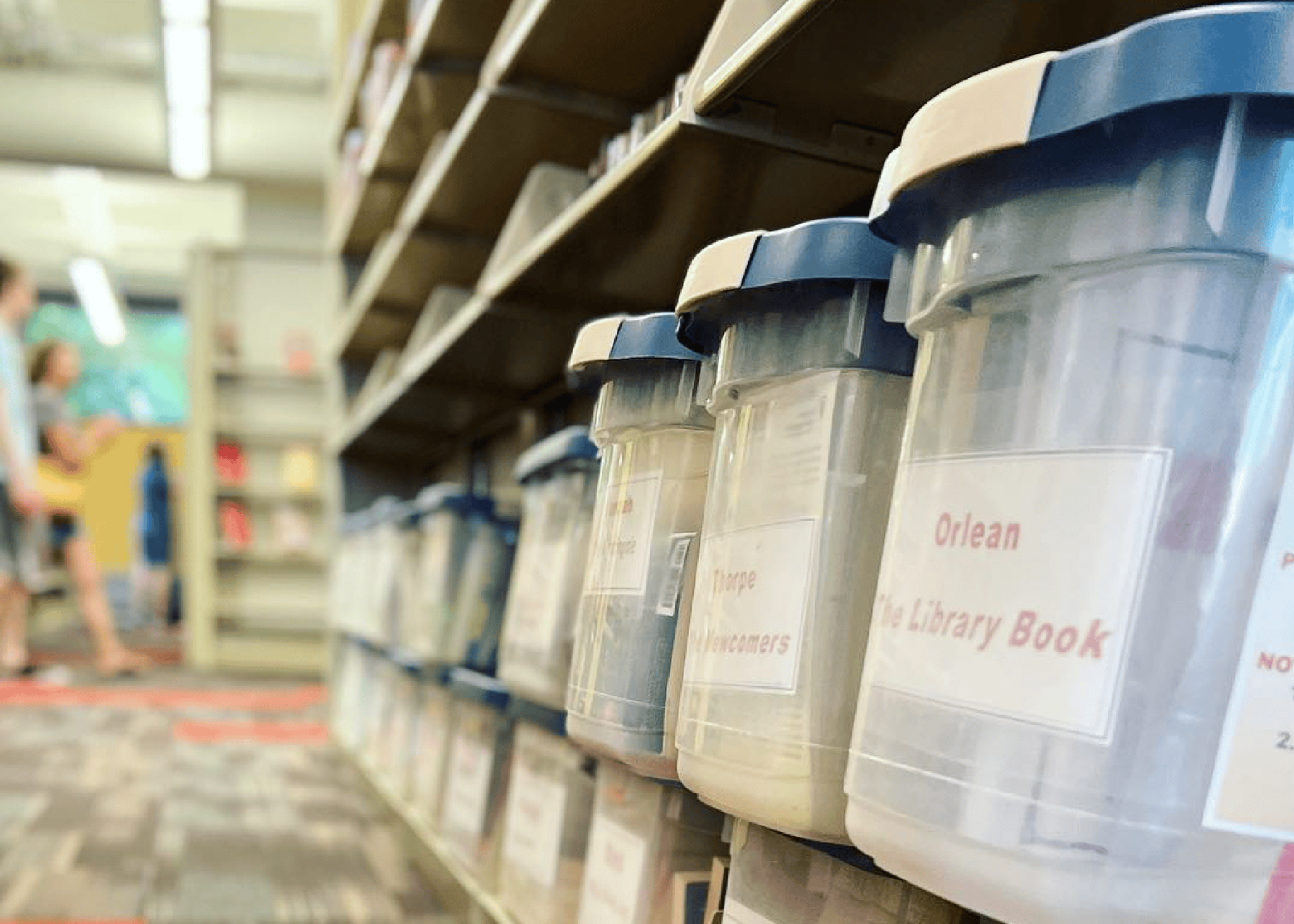 Plastic bins on a shelf in a library