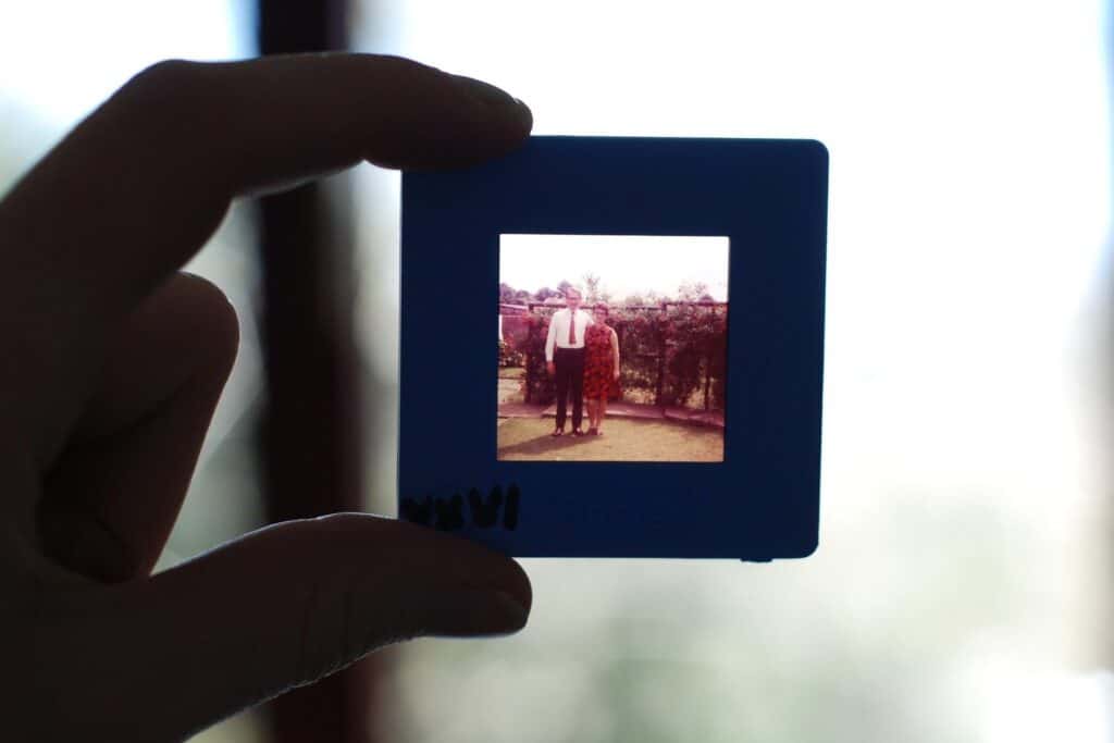 Hand holding up an old slide photo