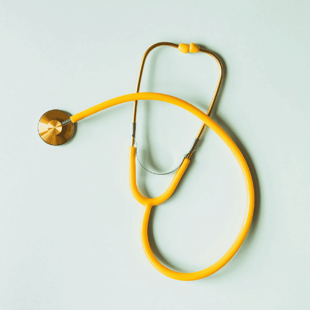 Yellow stethoscope on a light blue background