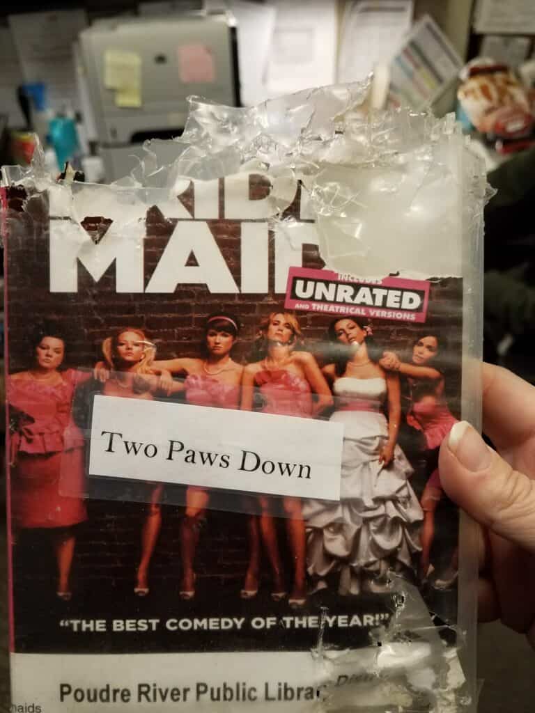 Shredded DVD case with the label "two paws down"