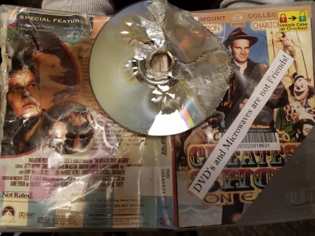 Burnt DVD with a label reading "DVD's and microwaves are not Friends"