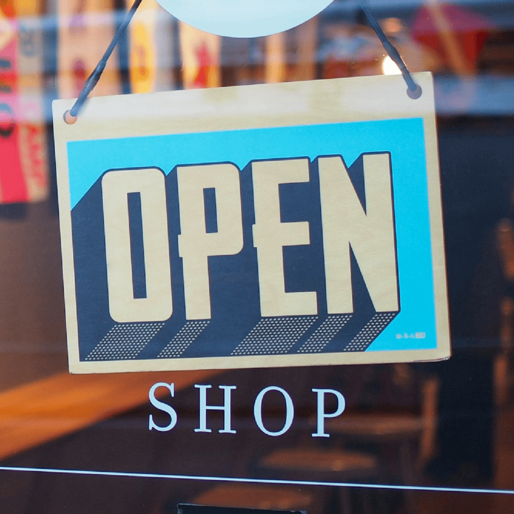 An open sign in the window of a shop