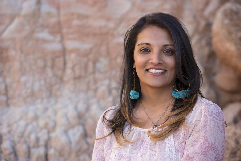 Author Sandhya Menon smiling for a photo outdoors