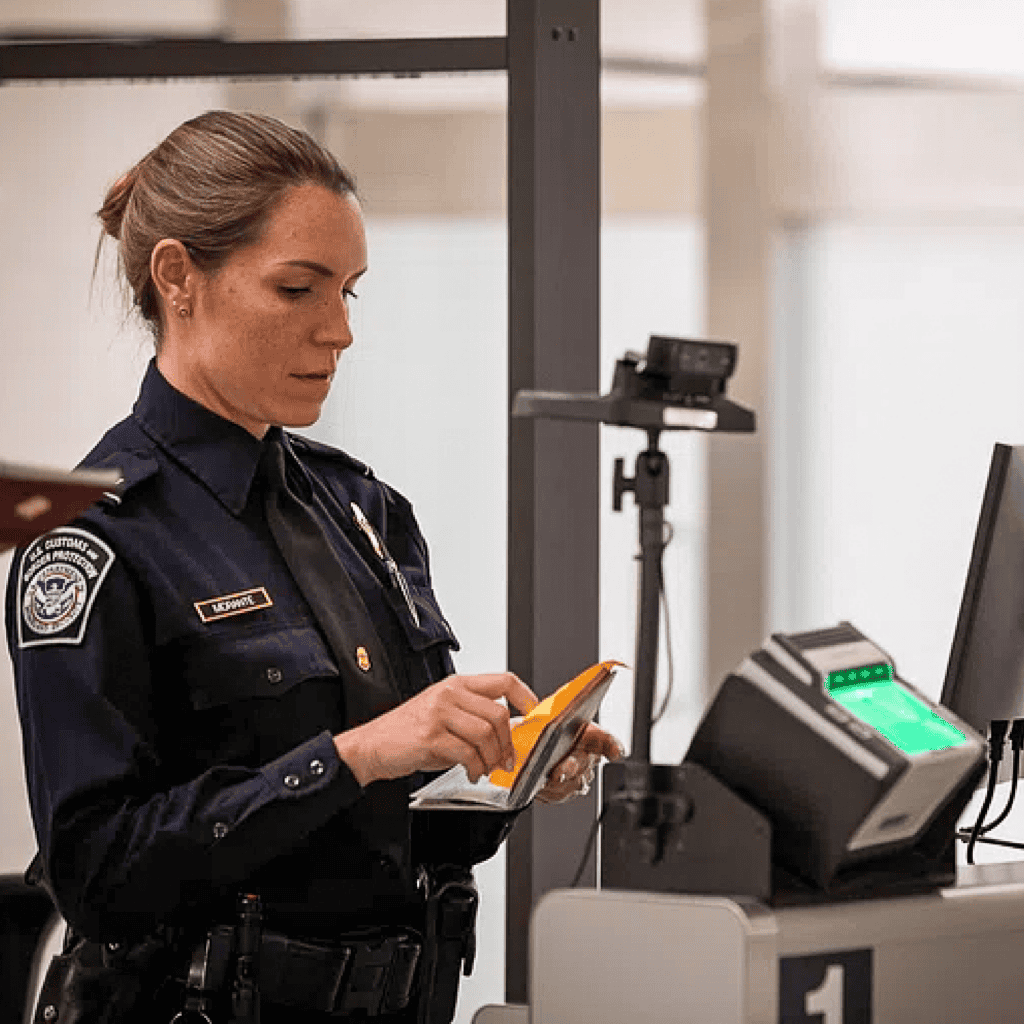 A woman TSA agent reading someone's passport