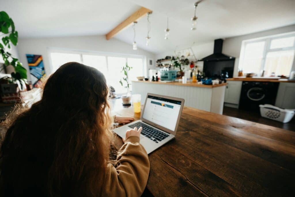 Teen girl looking at a laptop while seated