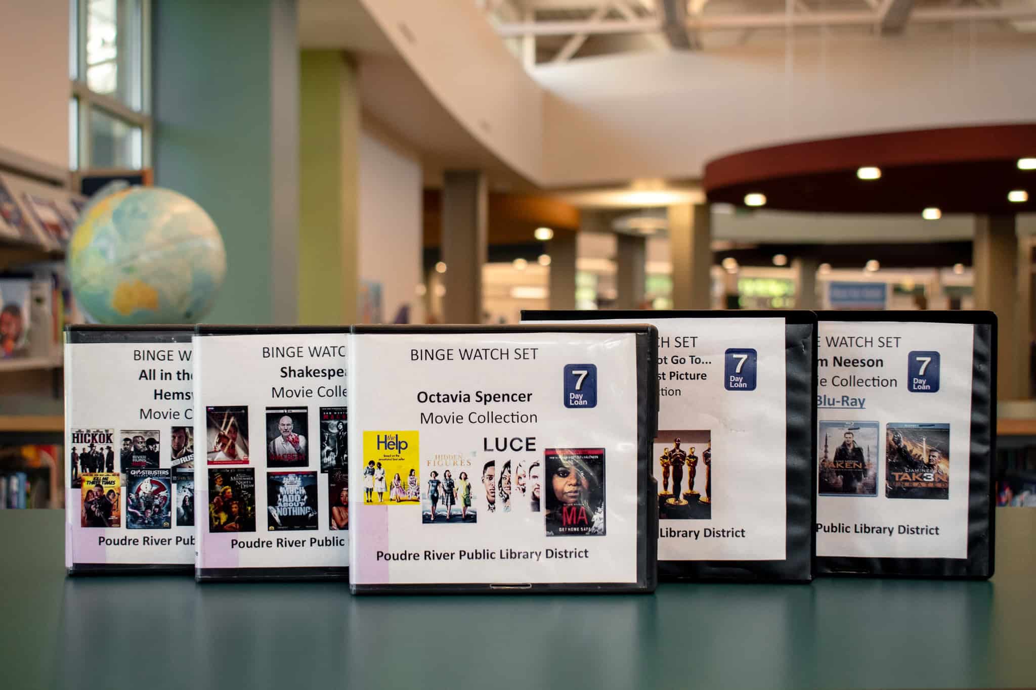 Themed DVD collections arranged in a library table