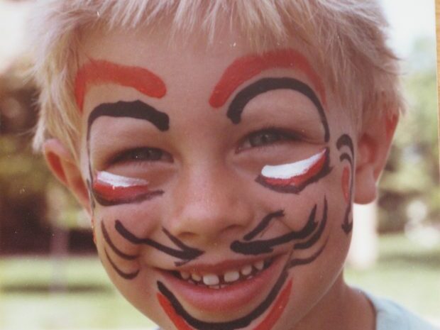 little boy with face paint smiling