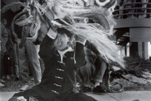 man holding up a traditional Chinese lion costume