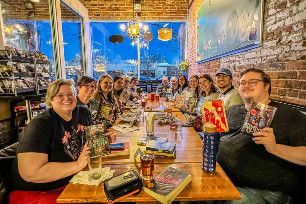 group of people smiling at a table