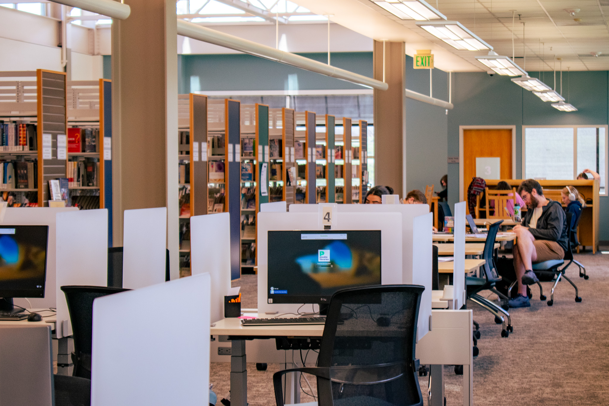 computers at bookshelves at harmony library