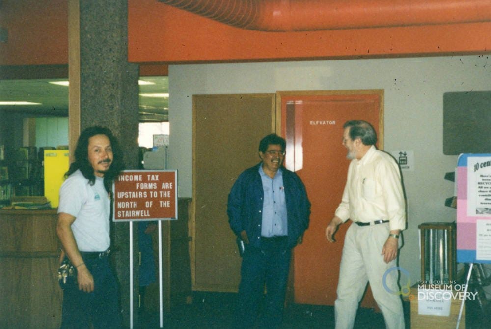 three men standing in the lobby of the new fort collins main library