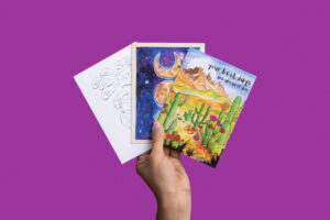 hand holding up 3 different greeting cards