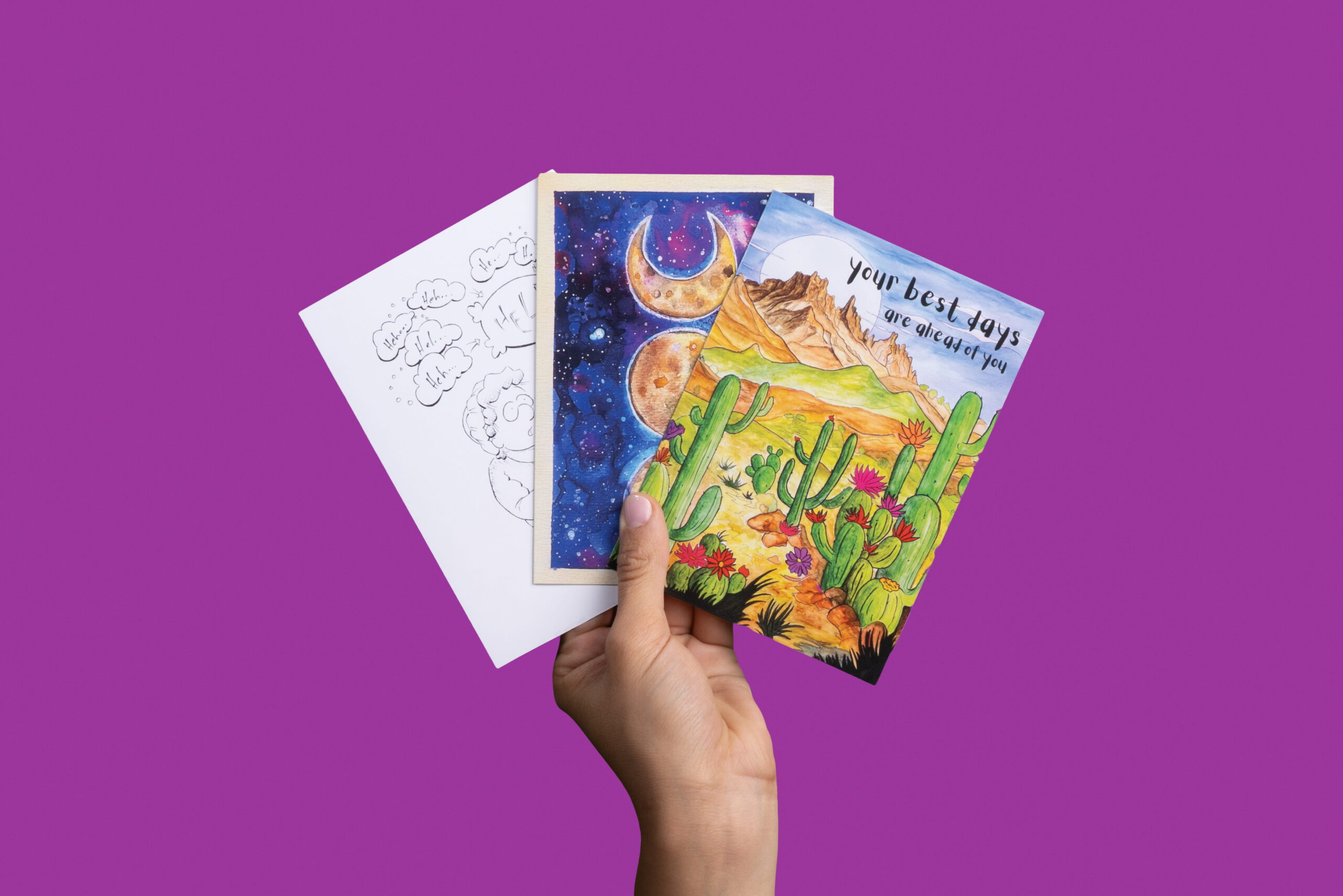 hand holding up 3 different greeting cards