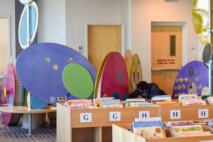 colorful circular structures and bookshelves in the children's section of council tree library
