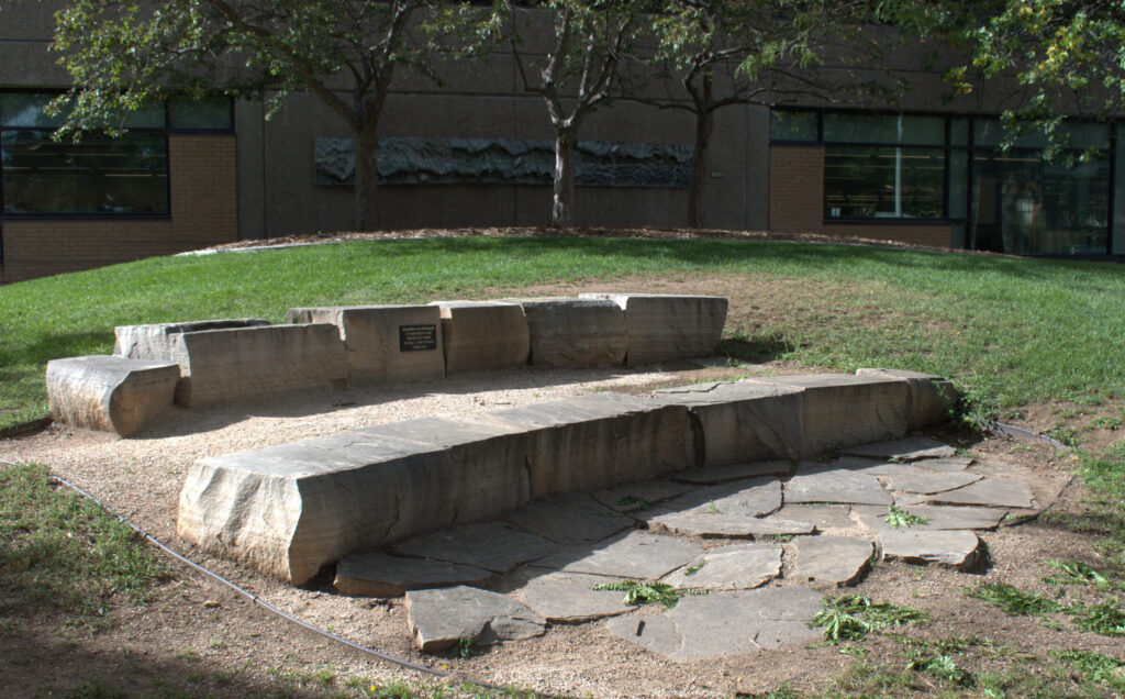Stone amphitheater seating on the north side of Old Town Library in Library Park.