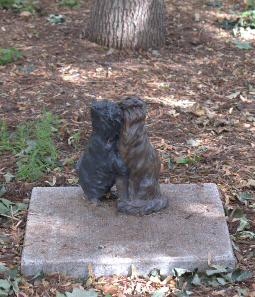 Small statue of a dog and a cat in Library Park