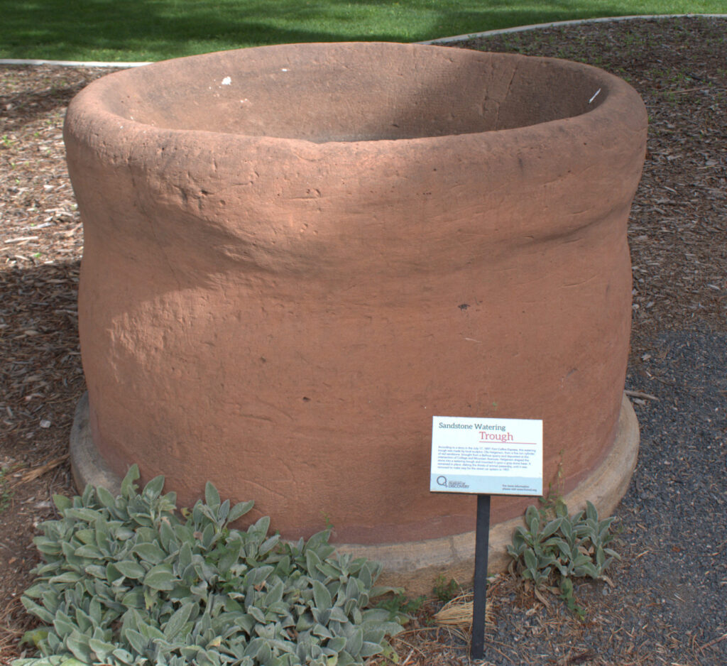 Large circular sandstone watering trough in front of the Center for Creativity in Library Park.