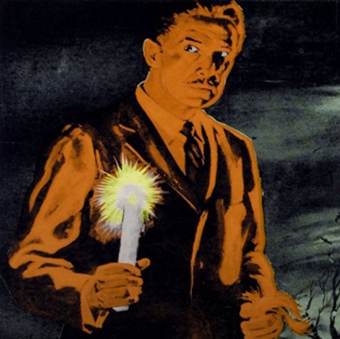 Noir image of man holding a candle